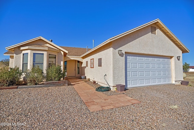 ranch-style house featuring a garage