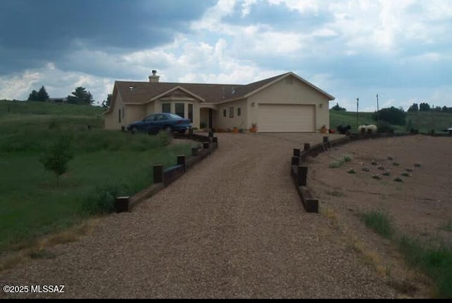 ranch-style house with an attached garage and driveway