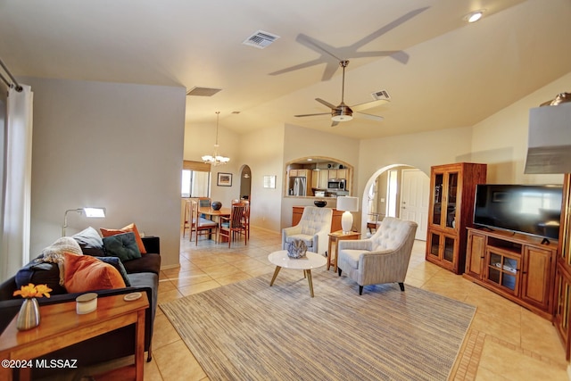 living area featuring arched walkways, visible vents, lofted ceiling, and light tile patterned flooring