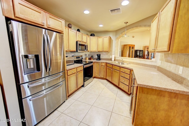 kitchen featuring visible vents, light countertops, light tile patterned floors, appliances with stainless steel finishes, and a sink