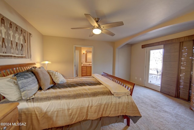 carpeted bedroom with ensuite bath, a ceiling fan, and access to outside