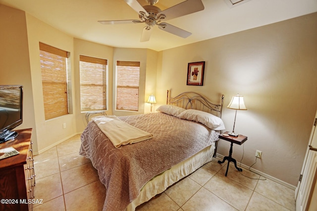 bedroom featuring light tile patterned flooring, baseboards, and ceiling fan