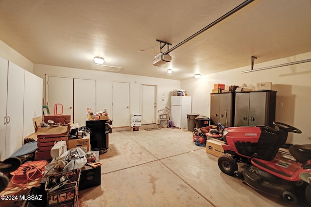 garage with a garage door opener and freestanding refrigerator