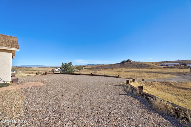 view of yard featuring a mountain view and a rural view