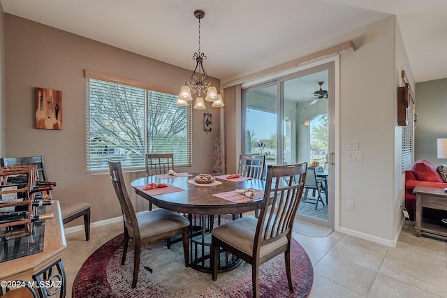 tiled dining area featuring ceiling fan with notable chandelier