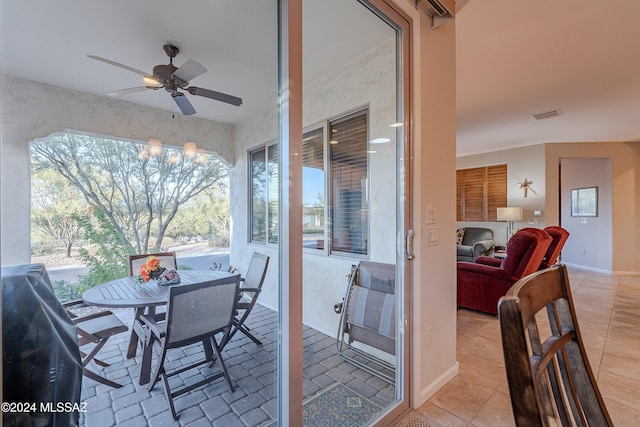 sunroom / solarium featuring ceiling fan