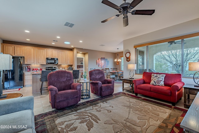 living room with ceiling fan and light tile patterned flooring