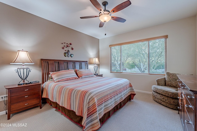 bedroom featuring ceiling fan and light carpet