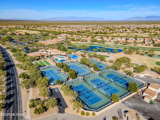 birds eye view of property with a water and mountain view