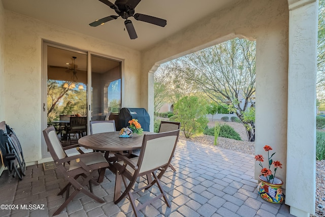 view of patio featuring ceiling fan and a grill