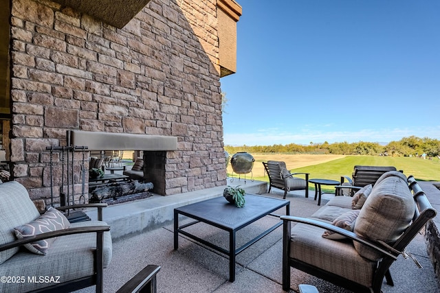 view of patio / terrace with an outdoor living space with a fireplace