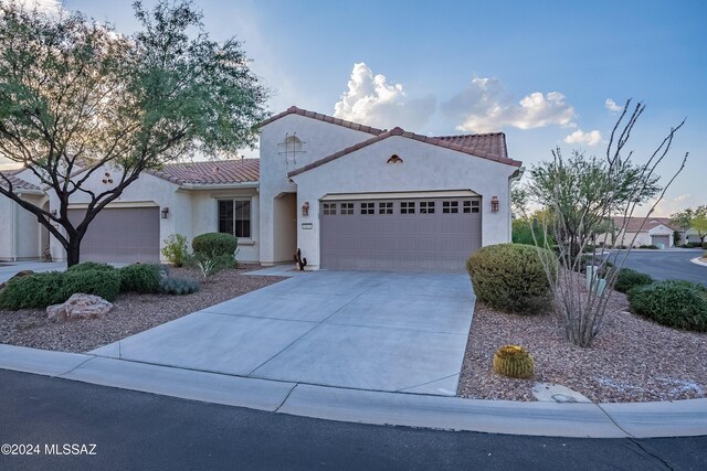 mediterranean / spanish home with a garage