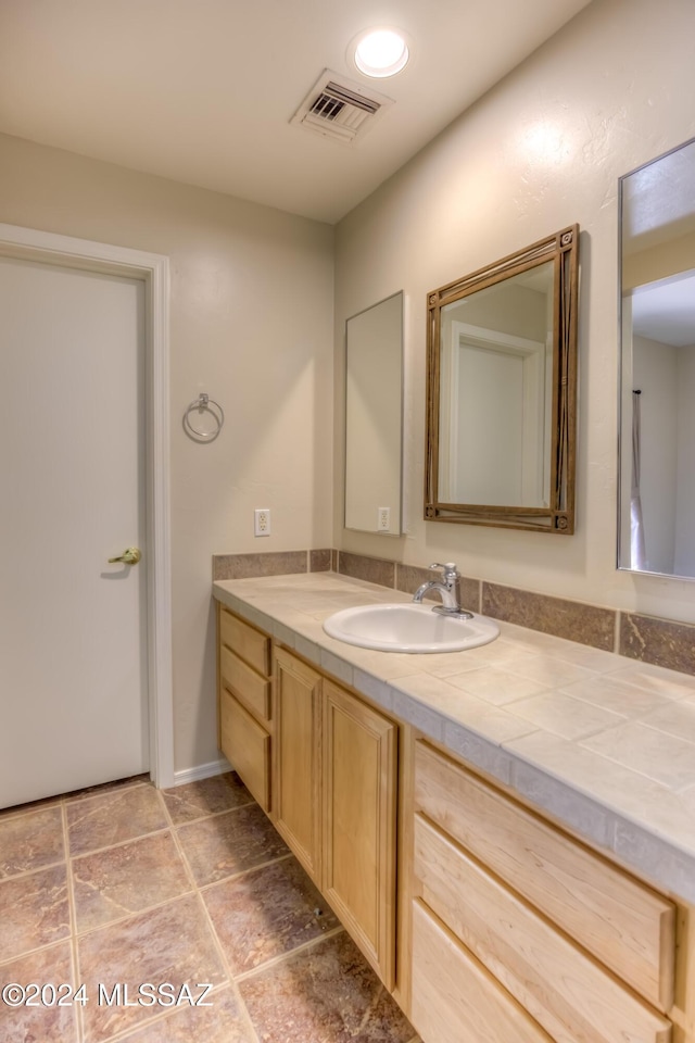 bathroom featuring visible vents and vanity