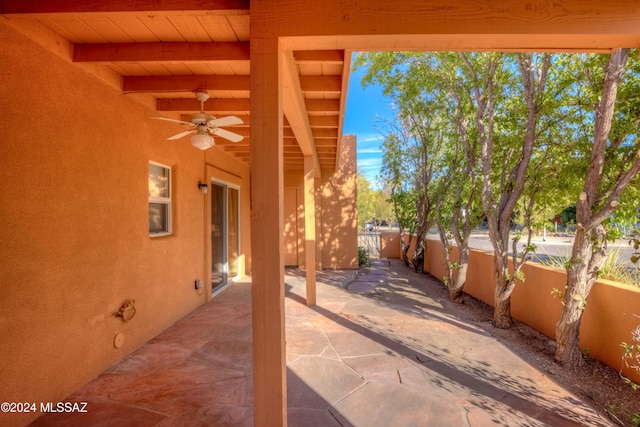 view of patio featuring fence and ceiling fan