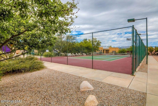 view of tennis court with fence