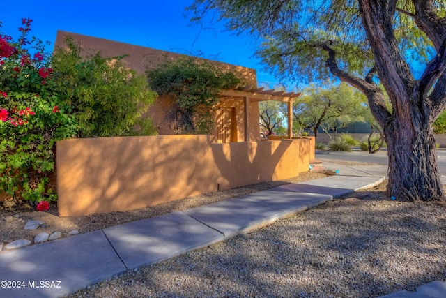 view of property exterior with a fenced front yard