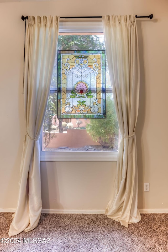 interior details featuring carpet and baseboards