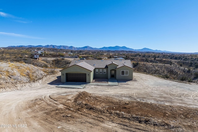 view of front of property featuring a mountain view and a garage