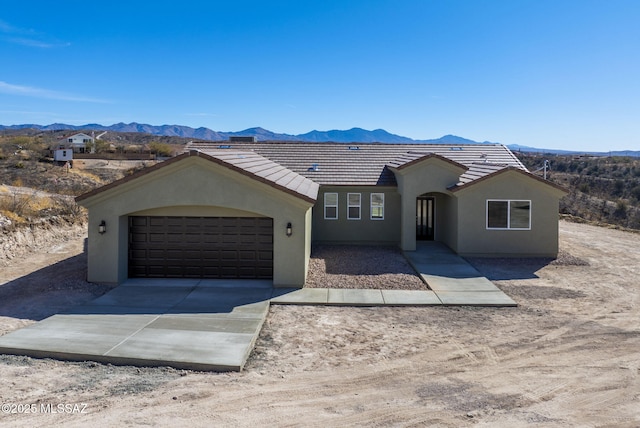 view of front facade featuring a garage and a mountain view