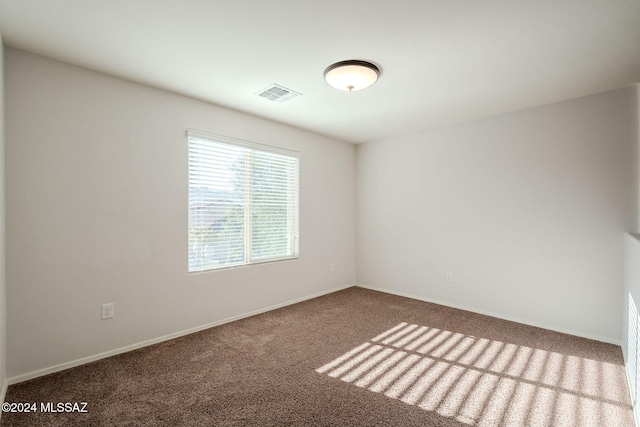 unfurnished room featuring carpet