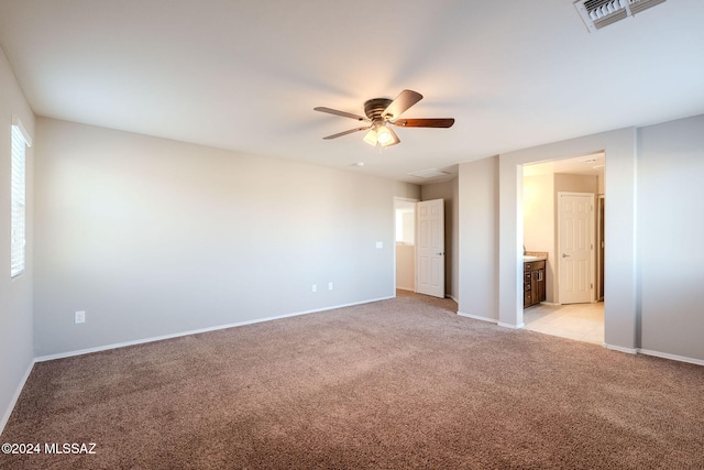 unfurnished room with light colored carpet and ceiling fan