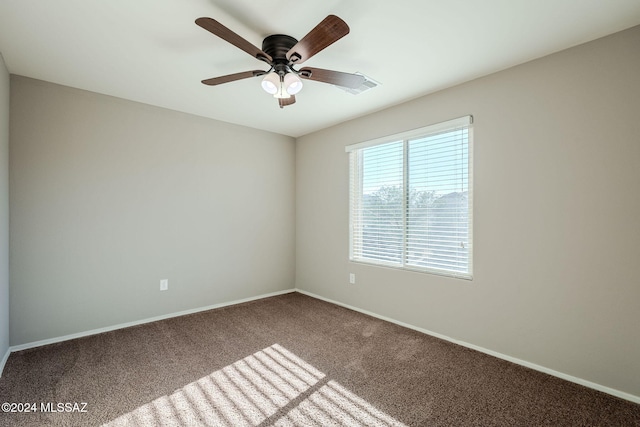 unfurnished room featuring ceiling fan and carpet