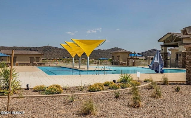 view of swimming pool with a mountain view and a patio