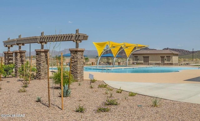 view of swimming pool with a mountain view