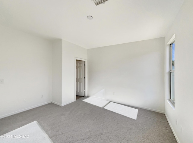 empty room featuring light carpet