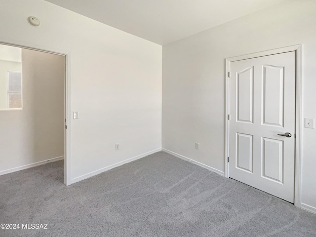 empty room featuring light colored carpet