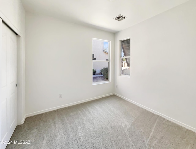 unfurnished bedroom with a closet and carpet