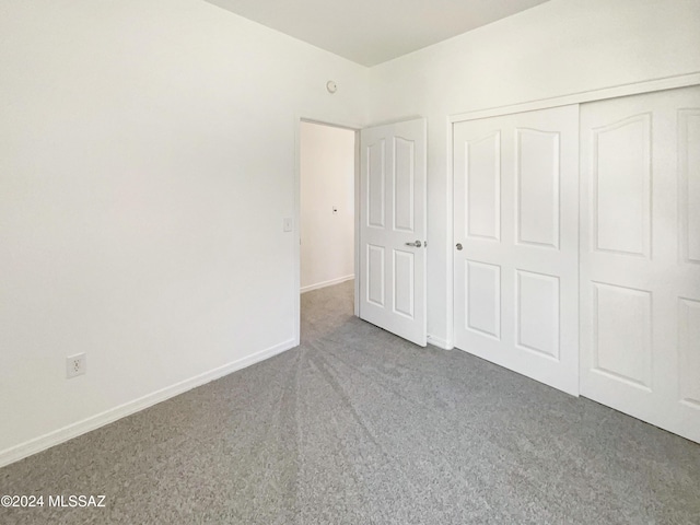 unfurnished bedroom with carpet and a closet