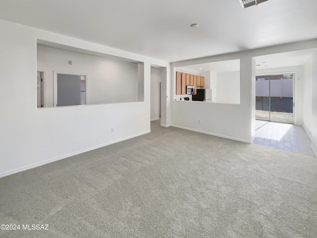 unfurnished living room featuring carpet floors