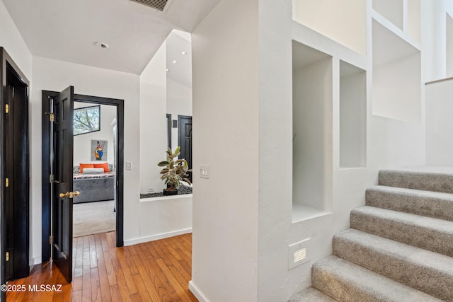 stairway with hardwood / wood-style floors