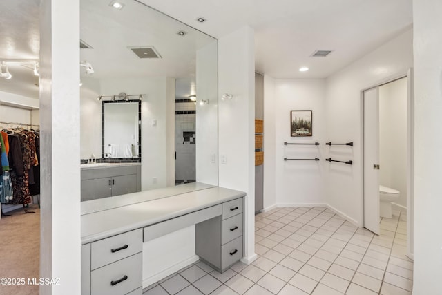 bathroom with vanity, toilet, and tile patterned flooring