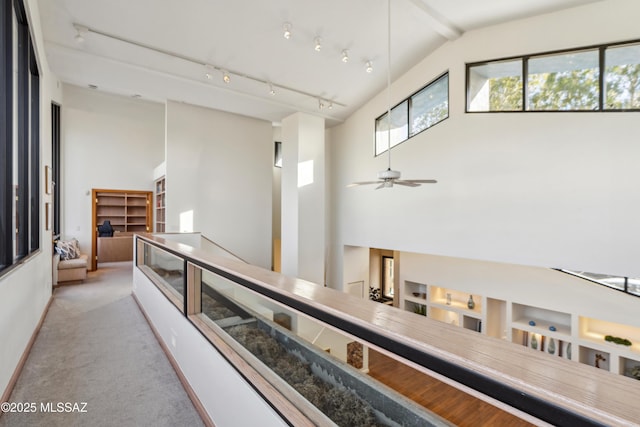 hall featuring light carpet and lofted ceiling