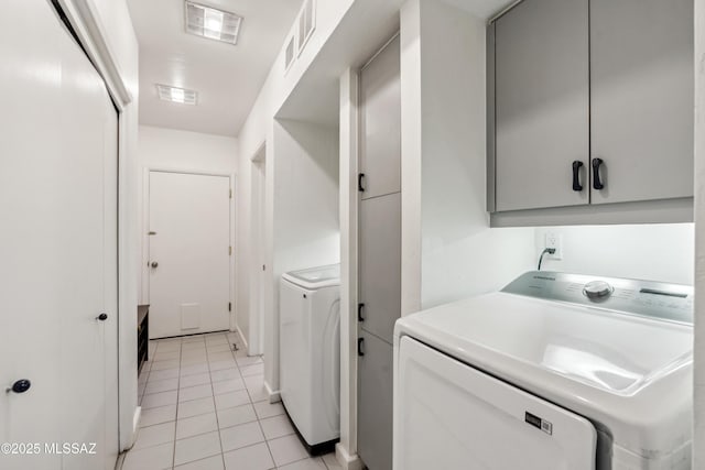 washroom with light tile patterned floors and independent washer and dryer