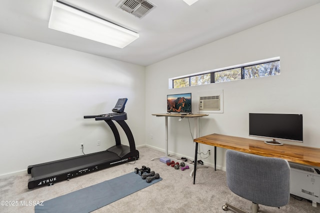 exercise area featuring carpet flooring and an AC wall unit