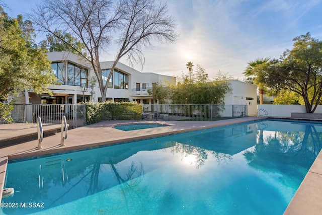 view of swimming pool with an in ground hot tub