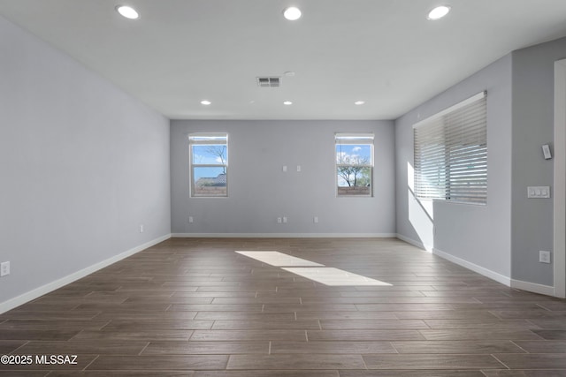 spare room featuring dark wood-type flooring