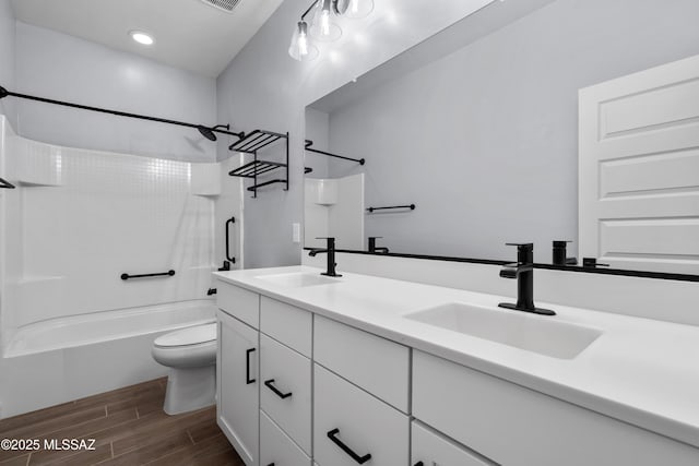 full bathroom with vanity, bathtub / shower combination, and toilet