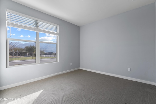 carpeted spare room featuring a mountain view