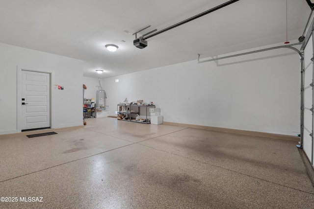 garage featuring a garage door opener and gas water heater