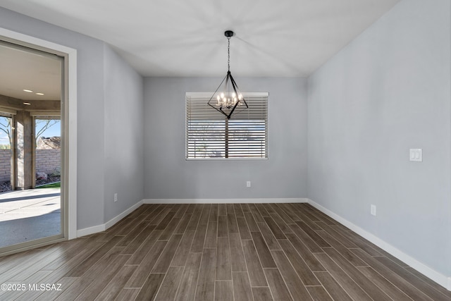 unfurnished dining area with a notable chandelier