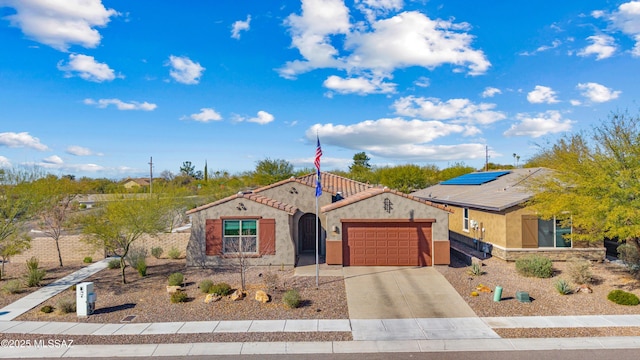 view of front of property featuring a garage and solar panels