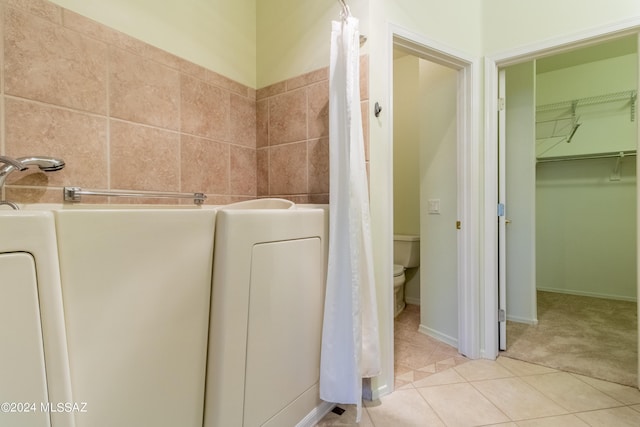 bathroom featuring tile patterned flooring and toilet