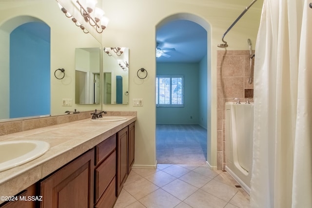 bathroom with tile patterned floors, ceiling fan, vanity, and walk in shower