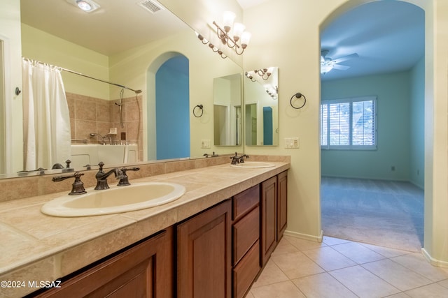 bathroom with tile patterned floors, ceiling fan, vanity, and plus walk in shower