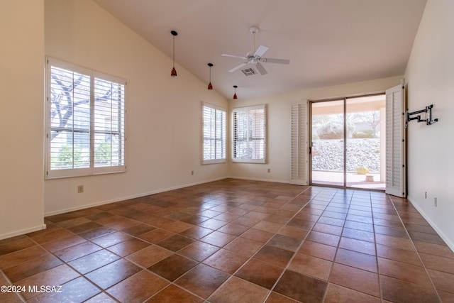 tiled empty room featuring ceiling fan and lofted ceiling