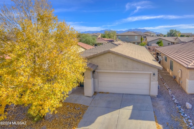 view of front of property featuring a mountain view and a garage